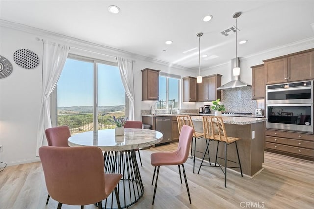 843 Longhorn Way, Rancho Mission Viejo, CA 92694 - dining space featuring plenty of natural light, crown molding, light wood-type flooring, recessed lighting, and baseboards