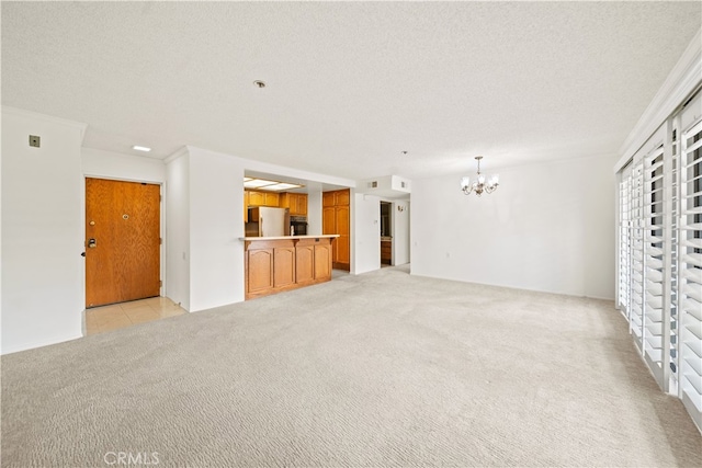 13601 Del Monte Dr Unit 75, Seal Beach, CA 90740 - unfurnished living room featuring a chandelier, light carpet, and a textured ceiling