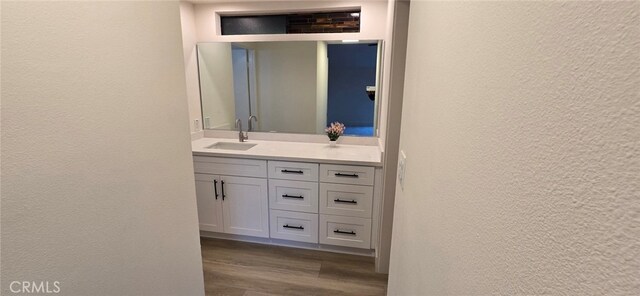 1364 Park Plaza Dr, Long Beach, CA 90804 - bathroom with a textured wall, vanity, and wood finished floors