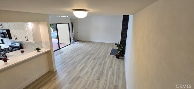 1364 Park Plaza Dr, Long Beach, CA 90804 - kitchen with stainless steel appliances, white cabinetry, decorative backsplash, light wood-type flooring, and light countertops