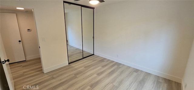 1364 Park Plaza Dr, Long Beach, CA 90804 - unfurnished bedroom featuring light wood-type flooring, baseboards, a closet, and ceiling fan