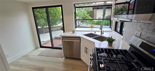 1364 Park Plaza Dr, Long Beach, CA 90804 - kitchen featuring stainless steel appliances, a sink, white cabinets, baseboards, and light countertops