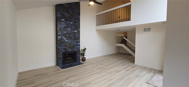 1364 Park Plaza Dr, Long Beach, CA 90804 - unfurnished living room with ceiling fan, stairs, wood finished floors, baseboards, and a tiled fireplace