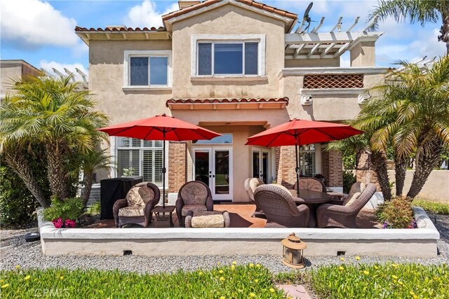 16 Via Barcaza, Coto De Caza, CA 92679 - back of property featuring french doors, stucco siding, a pergola, and a tiled roof