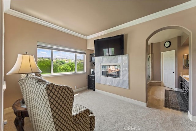 16 Via Barcaza, Coto De Caza, CA 92679 - living room with arched walkways, ornamental molding, a tiled fireplace, and carpet flooring