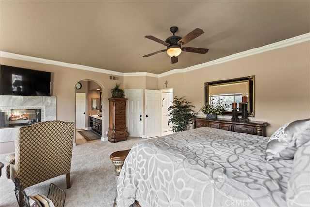 16 Via Barcaza, Coto De Caza, CA 92679 - carpeted bedroom featuring arched walkways, crown molding, a high end fireplace, ensuite bathroom, and ceiling fan