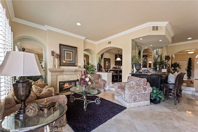 16 Via Barcaza, Coto De Caza, CA 92679 - living room with crown molding, a glass covered fireplace, arched walkways, and recessed lighting