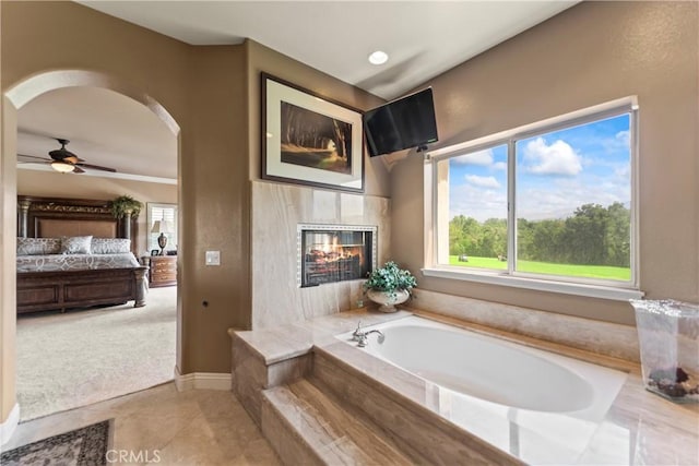 16 Via Barcaza, Coto De Caza, CA 92679 - ensuite bathroom featuring a bath, ceiling fan, and a fireplace