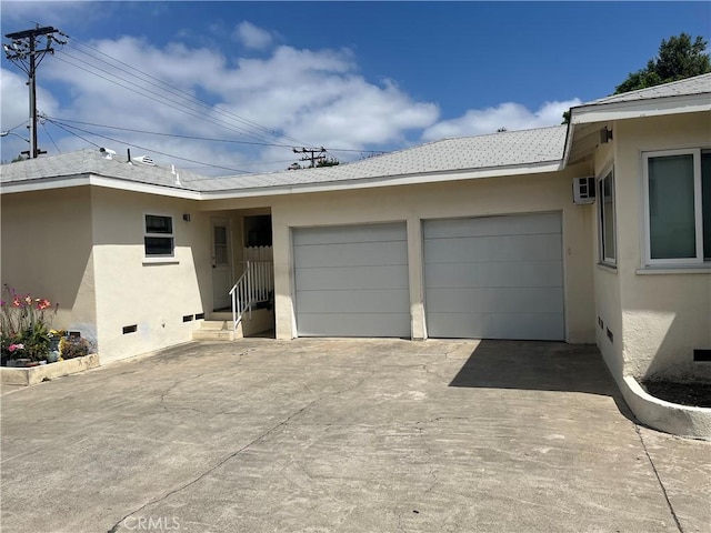 14782 Holt Ave, Tustin, CA 92780 - view of front of property with an attached garage, stucco siding, concrete driveway, and an AC wall unit