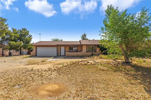 10793 Jamul Rd, Apple Valley, CA 92308 - view of front of property featuring a garage, stucco siding, and driveway