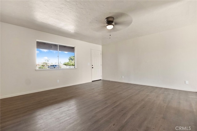 10793 Jamul Rd, Apple Valley, CA 92308 - spare room featuring dark wood-style flooring, ceiling fan, and baseboards