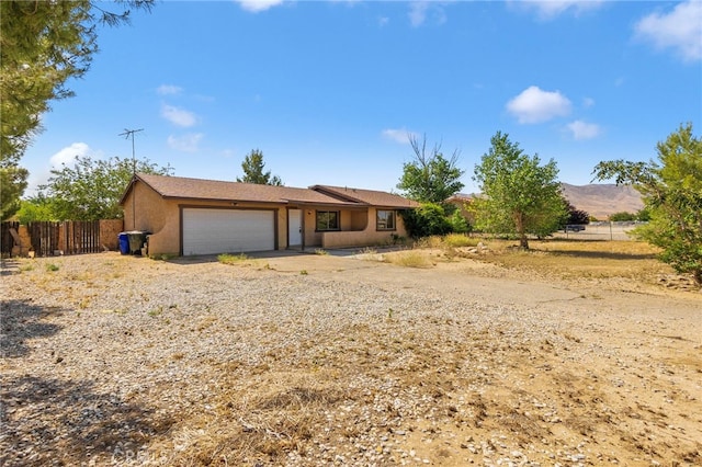 10793 Jamul Rd, Apple Valley, CA 92308 - ranch-style house with a garage, stucco siding, and driveway