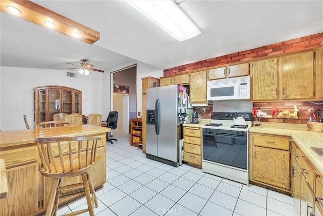 6765 Jadeite Ave, Rancho Cucamonga, CA 91701 - kitchen featuring white appliances, light countertops, ceiling fan, light tile patterned flooring, and backsplash