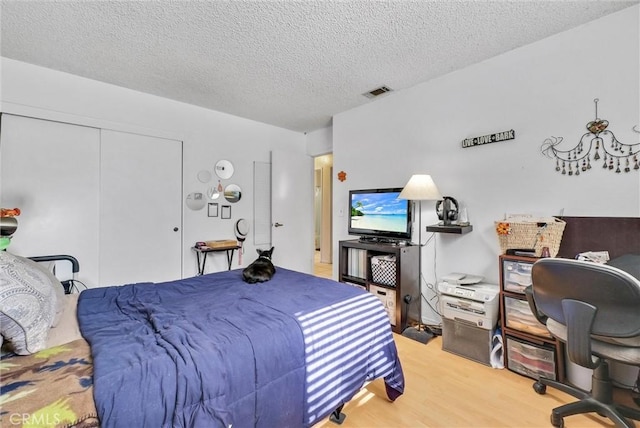 6765 Jadeite Ave, Rancho Cucamonga, CA 91701 - bedroom featuring wood finished floors, a closet, a textured ceiling, and an office area