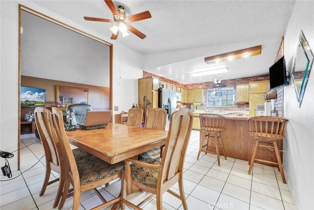 6765 Jadeite Ave, Rancho Cucamonga, CA 91701 - dining room featuring light tile patterned floors, a ceiling fan, vaulted ceiling, and a textured ceiling