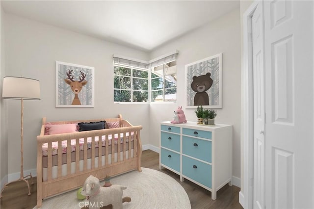 124 S Glengrove Ave, San Dimas, CA 91773 - bedroom featuring wood finished floors, baseboards, and a crib