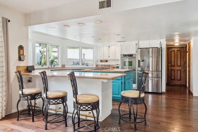 6978 Withers Rd, Riverside, CA 92506 - kitchen featuring stainless steel fridge with ice dispenser, a peninsula, white cabinetry, and dark wood-style floors