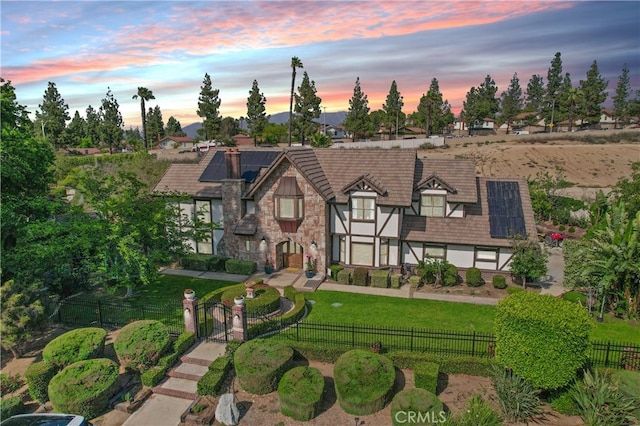 6978 Withers Rd, Riverside, CA 92506 - english style home featuring solar panels, a gate, a tile roof, and stone siding