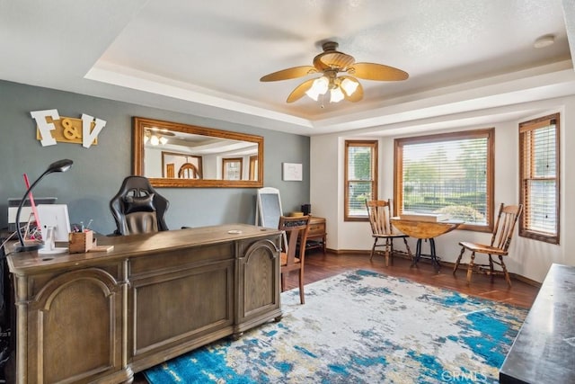 6978 Withers Rd, Riverside, CA 92506 - home office featuring a raised ceiling, ceiling fan, wood finished floors, and baseboards