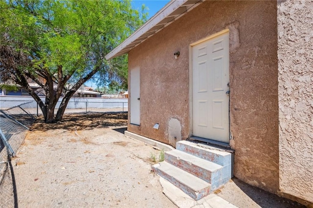 518 A St, Needles, CA 92363 - doorway to property featuring stucco siding