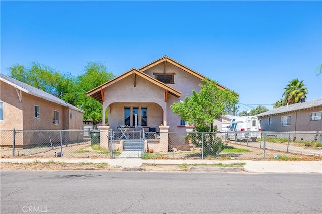 518 A St, Needles, CA 92363 - view of front facade featuring a fenced front yard, stucco siding, a gate, and a porch