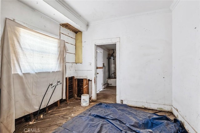 518 A St, Needles, CA 92363 - unfurnished bedroom featuring ornamental molding, water heater, and wood finished floors