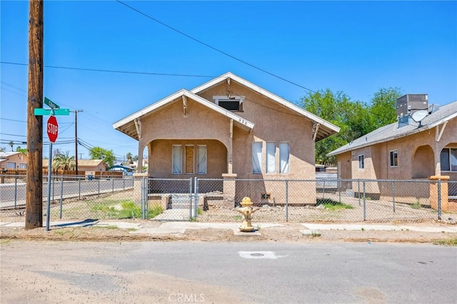 518 A St, Needles, CA 92363 - view of front of property with stucco siding, a fenced front yard, and a gate