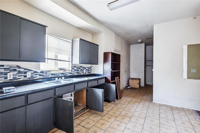 518 A St, Needles, CA 92363 - kitchen with decorative backsplash, a sink, dark countertops, and gray cabinets