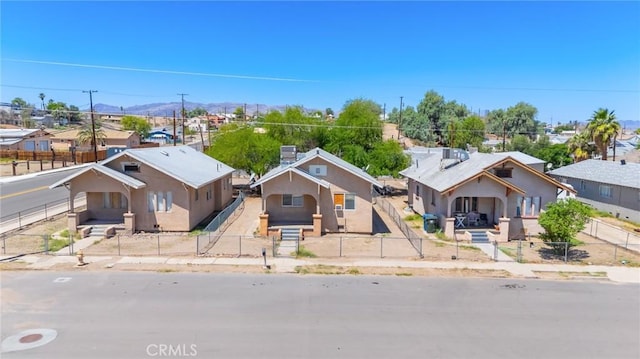 518 A St, Needles, CA 92363 - view of front facade featuring a residential view, a fenced backyard, a mountain view, and stucco siding