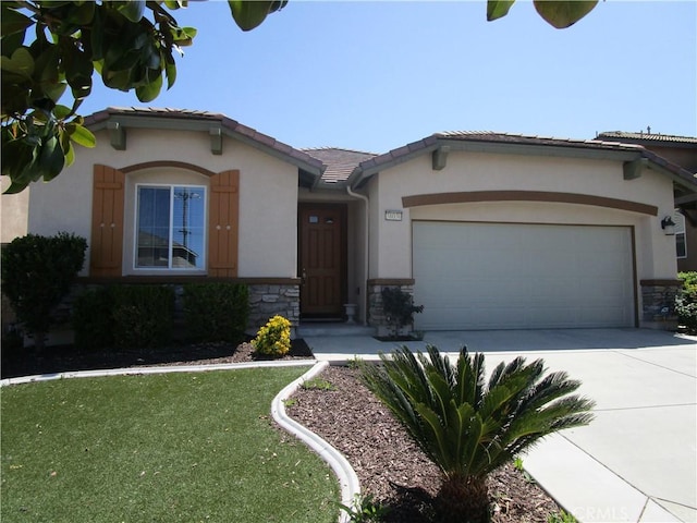 38030 Turning Leaf Ct, Murrieta, CA 92563 - view of front of house featuring stone siding, a garage, concrete driveway, and stucco siding