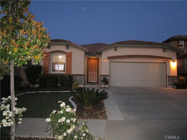 38030 Turning Leaf Ct, Murrieta, CA 92563 - mediterranean / spanish home with a garage, stone siding, concrete driveway, and stucco siding