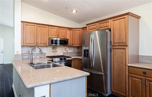 2069 W Fairview Dr, Rialto, CA 92377 - kitchen featuring appliances with stainless steel finishes, a sink, vaulted ceiling, a peninsula, and decorative backsplash