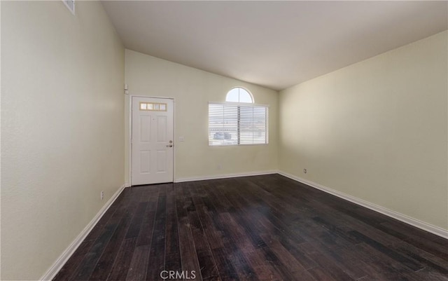 2069 W Fairview Dr, Rialto, CA 92377 - unfurnished room with dark wood-style flooring, vaulted ceiling, and baseboards