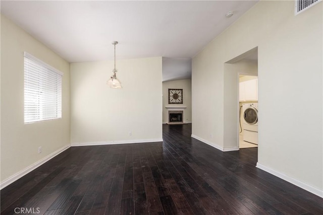 2069 W Fairview Dr, Rialto, CA 92377 - unfurnished living room with washer / clothes dryer, dark wood-type flooring, baseboards, and a fireplace