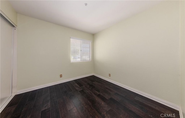 2069 W Fairview Dr, Rialto, CA 92377 - unfurnished bedroom with dark wood finished floors, baseboards, and a closet