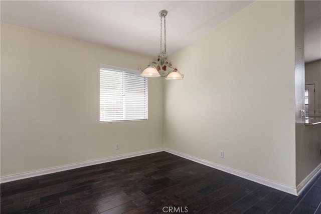 2069 W Fairview Dr, Rialto, CA 92377 - empty room featuring dark wood-type flooring, baseboards, and a chandelier