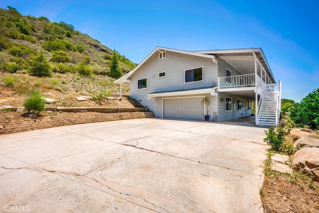 44196 La Cruz Dr, Temecula, CA 92590 - view of side of property with stairs, an attached garage, driveway, and a carport
