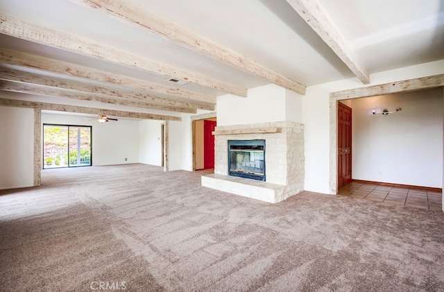44196 La Cruz Dr, Temecula, CA 92590 - unfurnished living room with beamed ceiling, carpet flooring, a glass covered fireplace, and a ceiling fan