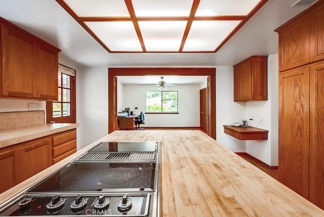 44196 La Cruz Dr, Temecula, CA 92590 - kitchen with an office area, wood counters, ceiling fan, and brown cabinets