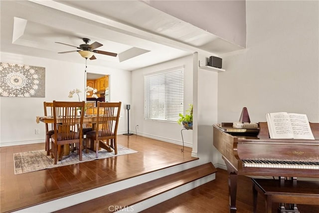 11818 Pocasset Dr, Whittier, CA 90601 - dining room featuring a raised ceiling, wood finished floors, and a ceiling fan