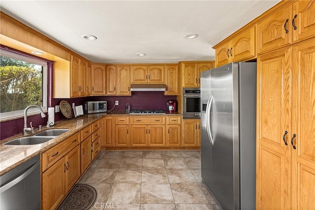 11818 Pocasset Dr, Whittier, CA 90601 - kitchen featuring stainless steel appliances, under cabinet range hood, light stone countertops, recessed lighting, and brown cabinetry