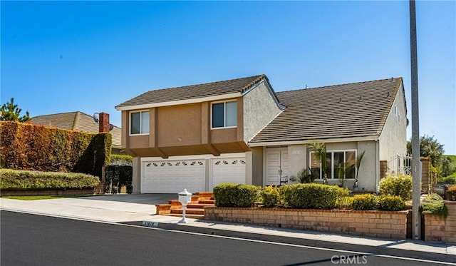 11818 Pocasset Dr, Whittier, CA 90601 - view of front of home featuring stucco siding, an attached garage, a tile roof, and concrete driveway