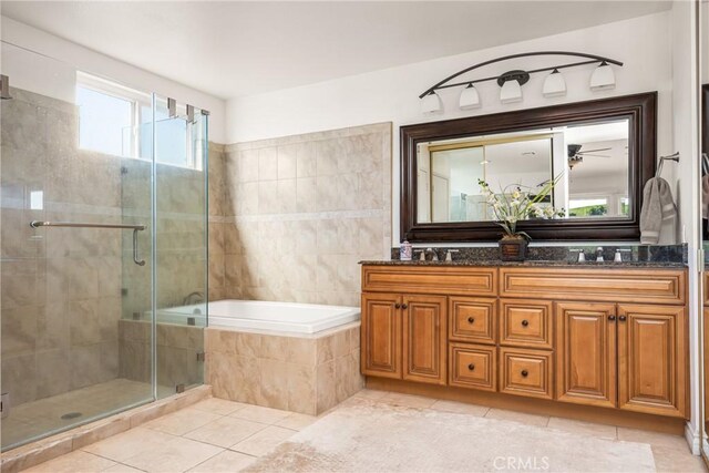11818 Pocasset Dr, Whittier, CA 90601 - bathroom featuring double vanity, tile patterned floors, a bath, a stall shower, and a ceiling fan