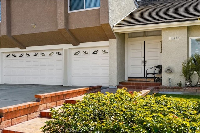 11818 Pocasset Dr, Whittier, CA 90601 - doorway to property featuring an attached garage and stucco siding