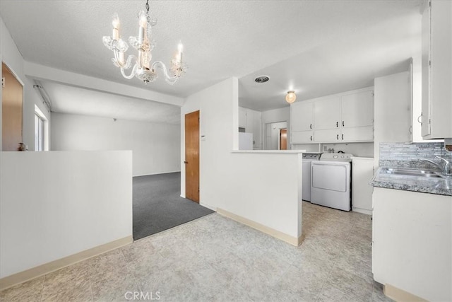 1646 W 168th St, Gardena, CA 90247 - kitchen with a sink, washer and clothes dryer, a chandelier, white cabinetry, and refrigerator