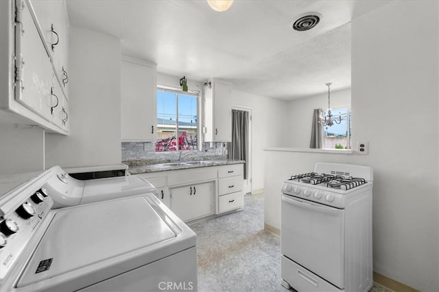 1646 W 168th St, Gardena, CA 90247 - laundry room with washing machine and dryer, a chandelier, and baseboards