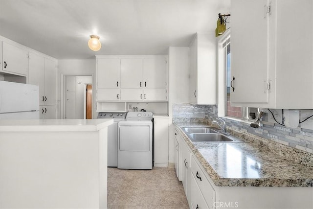 1646 W 168th St, Gardena, CA 90247 - kitchen featuring washing machine and dryer, a sink, white cabinets, backsplash, and healthy amount of natural light