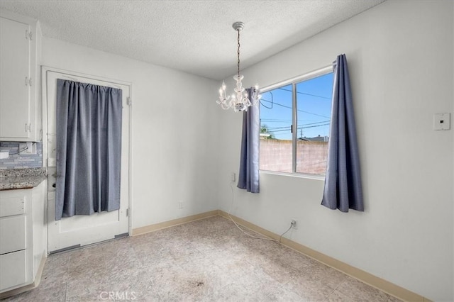 1646 W 168th St, Gardena, CA 90247 - unfurnished dining area featuring a chandelier, a textured ceiling, and baseboards