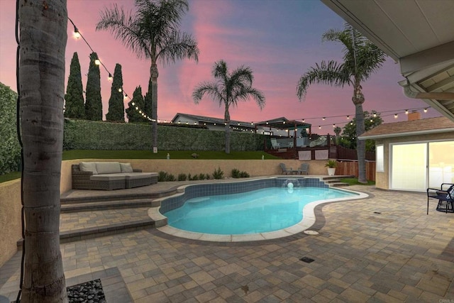 970 Carlsbad St, San Diego, CA 92114 - pool at dusk with a patio, a fenced backyard, and an outdoor structure