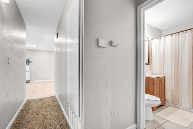 970 Carlsbad St, San Diego, CA 92114 - full bath featuring tile patterned flooring, toilet, vanity, a textured wall, and baseboards